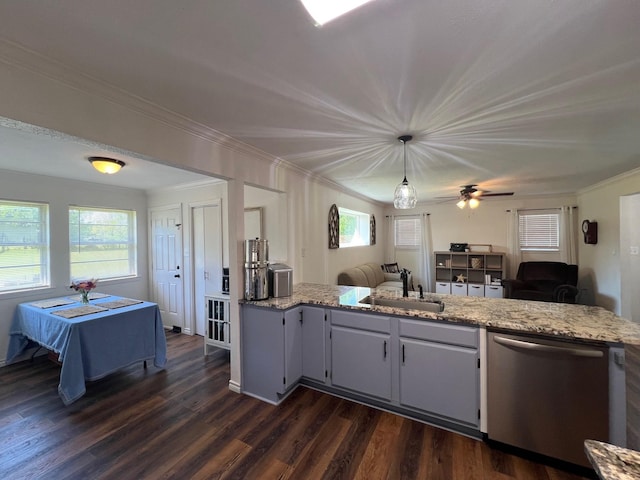 kitchen featuring crown molding, stainless steel dishwasher, a sink, and light stone countertops