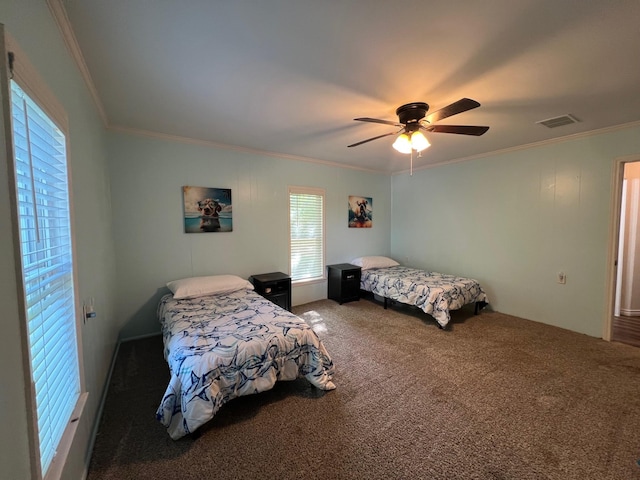 bedroom with carpet flooring, visible vents, crown molding, and ceiling fan