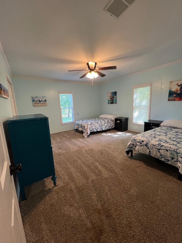 bedroom featuring crown molding, visible vents, multiple windows, and carpet