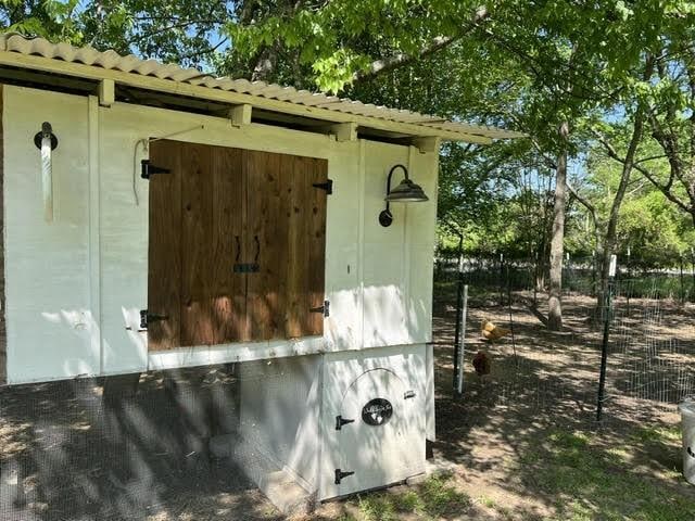 view of outbuilding featuring fence