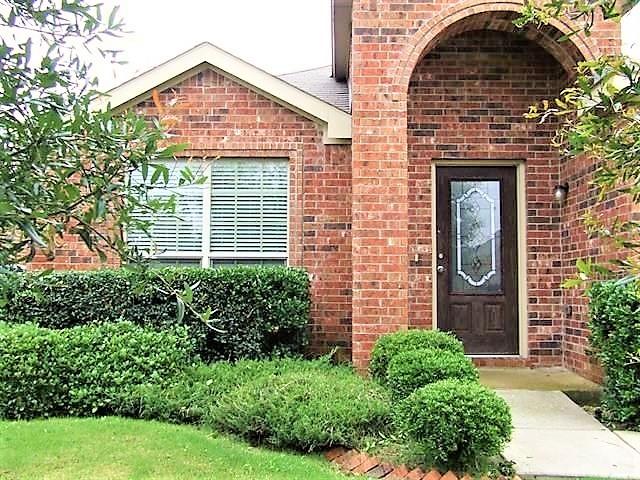 entrance to property featuring brick siding