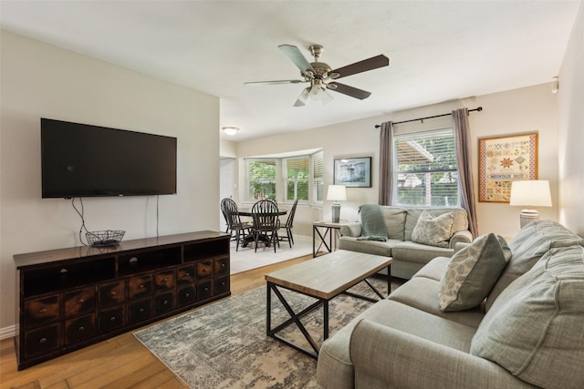 1202 Johns Dr, Euless, TX 76039 - living area with light wood-style flooring, a ceiling fan, and baseboards