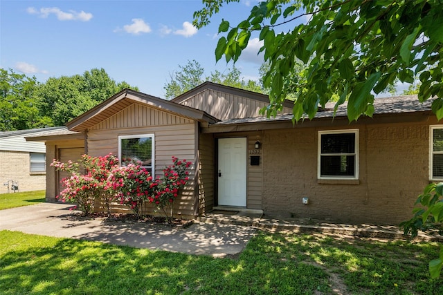 1202 Johns Dr, Euless, TX 76039 - view of front of home featuring a garage, a front yard, and brick siding