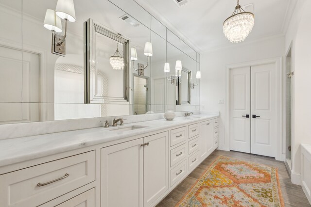 6622 Blue Valley Ln, Dallas, TX 75214 - bathroom featuring a sink, ornamental molding, double vanity, and a chandelier
