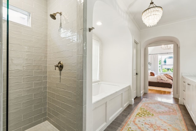 6622 Blue Valley Ln, Dallas, TX 75214 - ensuite bathroom featuring plenty of natural light, ensuite bathroom, crown molding, tiled shower, and wood finished floors