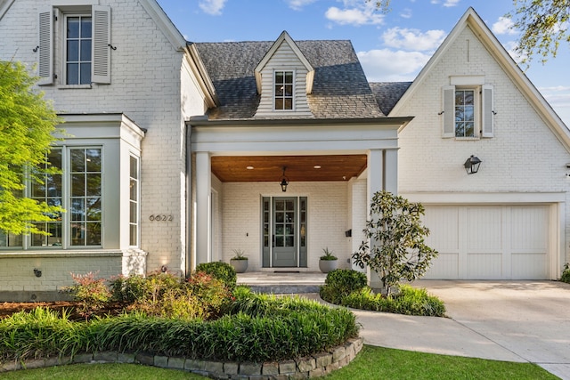 6622 Blue Valley Ln, Dallas, TX 75214 - view of front facade with a porch, a garage, concrete driveway, and brick siding