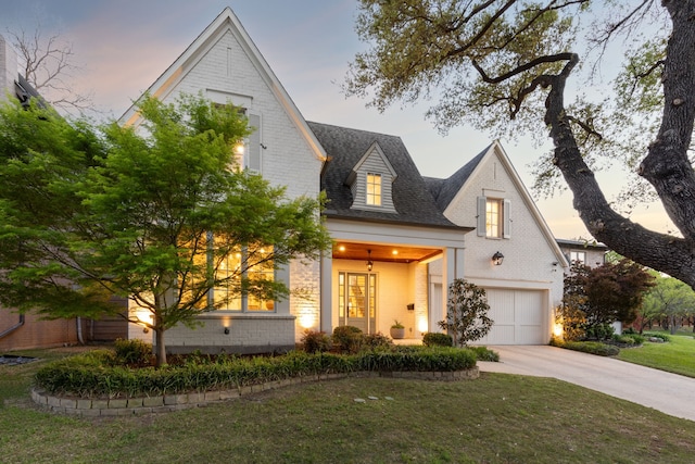 6622 Blue Valley Ln, Dallas, TX 75214 - view of front of property with a garage, a front yard, brick siding, and driveway