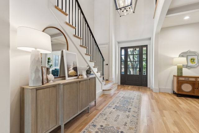 6622 Blue Valley Ln, Dallas, TX 75214 - foyer featuring stairway, light wood-type flooring, and baseboards