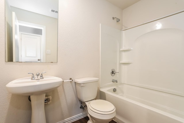 bathroom with visible vents, shower / tub combination, and toilet