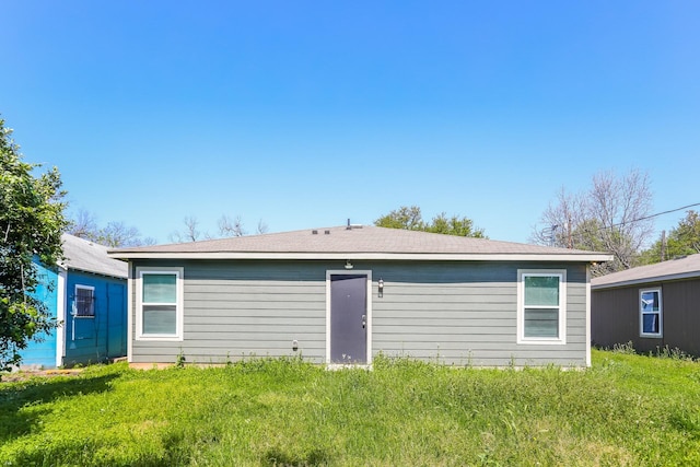 rear view of house with a yard