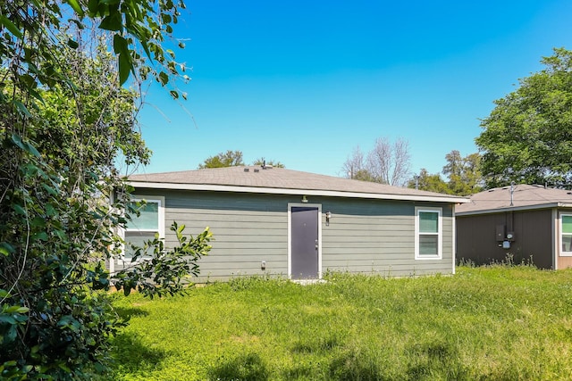 rear view of property with a yard