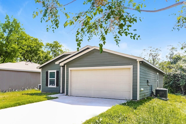ranch-style house featuring central AC unit and concrete driveway