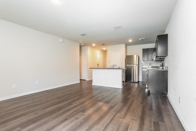 unfurnished living room featuring baseboards, dark wood-style floors, visible vents, and recessed lighting