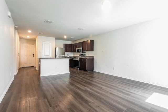 kitchen with dark wood-style flooring, baseboards, dark brown cabinets, visible vents, and stainless steel appliances