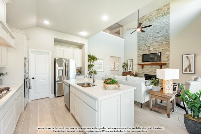 833 Blue Yucca Ln, Little Elm, TX 76227 - kitchen featuring wood finish floors, premium range hood, white cabinetry, ceiling fan, and a sink