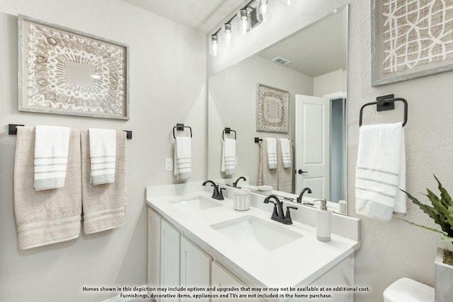 833 Blue Yucca Ln, Little Elm, TX 76227 - bathroom with double vanity, visible vents, a sink, and toilet