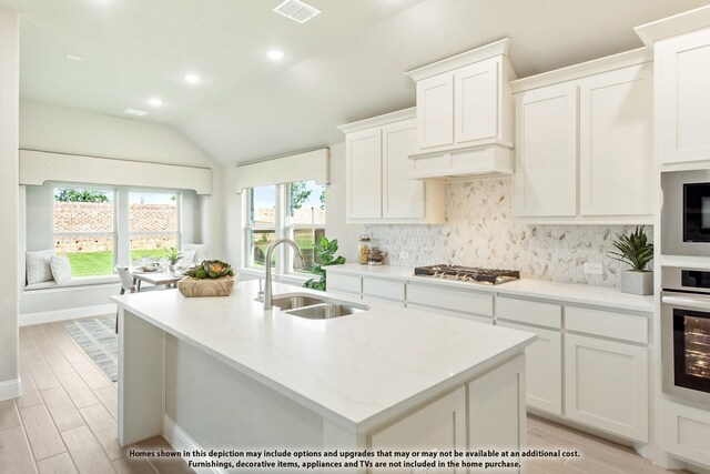 833 Blue Yucca Ln, Little Elm, TX 76227 - kitchen with vaulted ceiling, recessed lighting, a sink, stainless steel appliances, and decorative backsplash