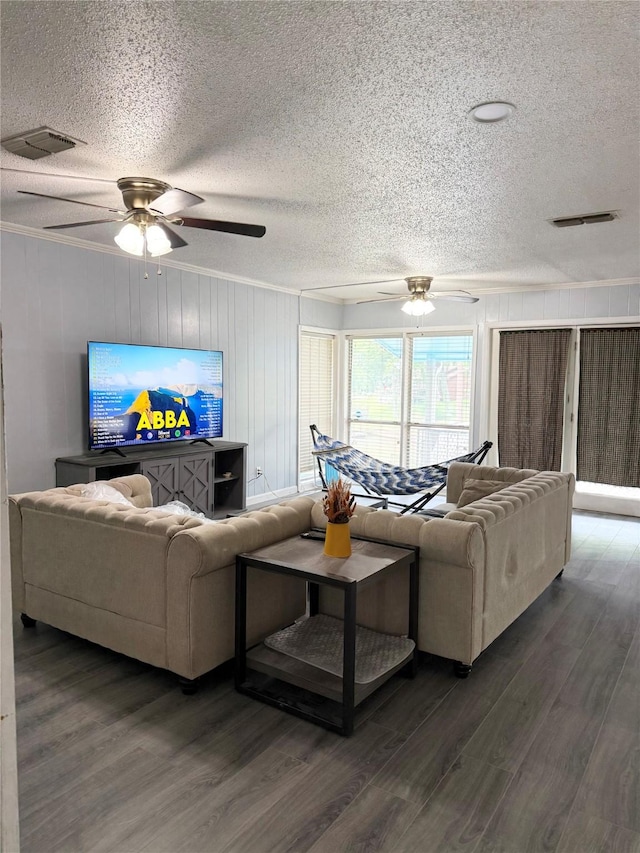 living room with a textured ceiling, ceiling fan, and visible vents