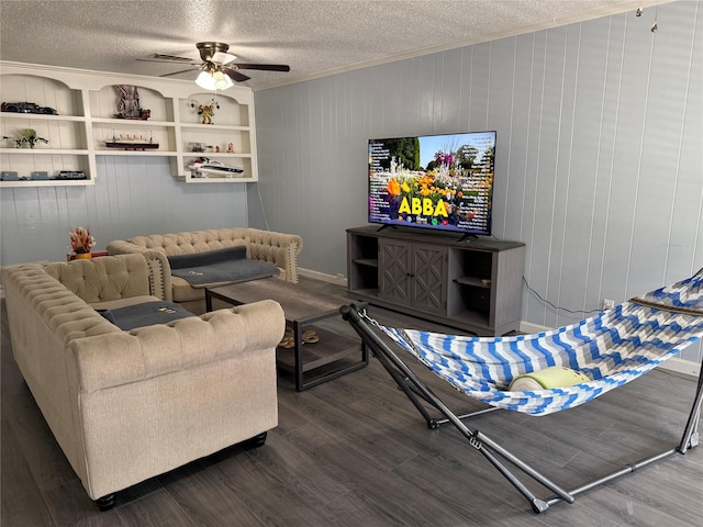 living room featuring crown molding, a ceiling fan, and a textured ceiling