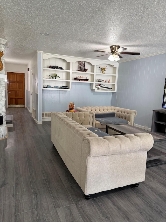 living area with dark wood-style floors, a textured ceiling, ceiling fan, and baseboards