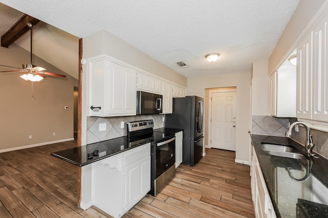 kitchen featuring light wood-style flooring, a sink, electric range, and white cabinetry