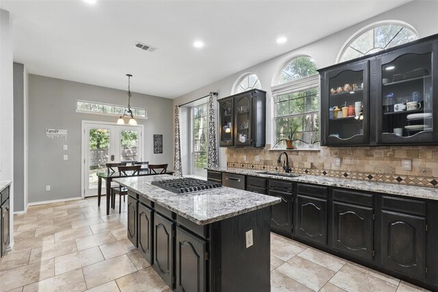 805 Red Oak Ct, Crowley, TX 76036 - kitchen featuring a sink, dark cabinetry, tasteful backsplash, a kitchen island, and recessed lighting