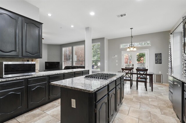 805 Red Oak Ct, Crowley, TX 76036 - kitchen featuring appliances with stainless steel finishes, a kitchen island, recessed lighting, light stone countertops, and hanging light fixtures