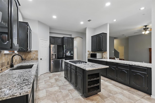 805 Red Oak Ct, Crowley, TX 76036 - kitchen featuring a sink, appliances with stainless steel finishes, backsplash, ceiling fan, and light stone countertops