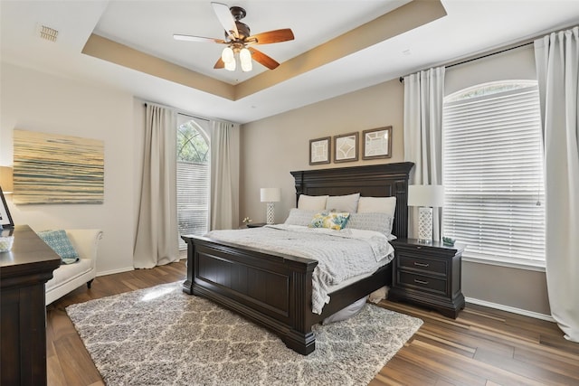 805 Red Oak Ct, Crowley, TX 76036 - bedroom with a raised ceiling, baseboards, dark wood-type flooring, and ceiling fan