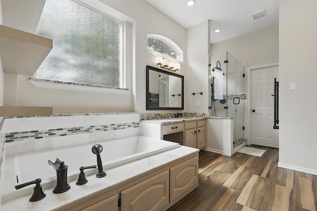805 Red Oak Ct, Crowley, TX 76036 - bathroom featuring a shower stall, a garden tub, wood finished floors, vanity, and recessed lighting