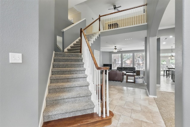 805 Red Oak Ct, Crowley, TX 76036 - stairway featuring ceiling fan, arched walkways, and a high ceiling