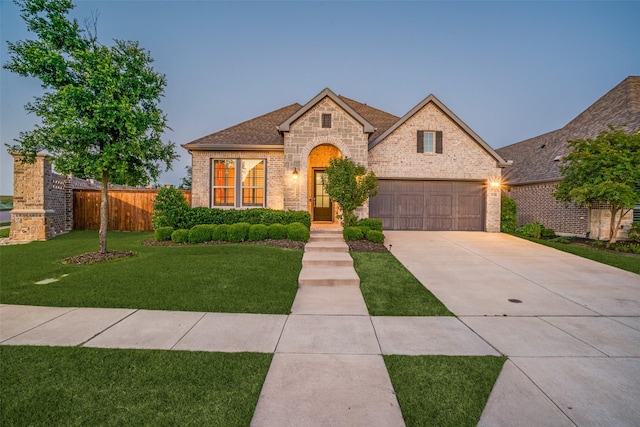 3128 Lexington Dr, Celina, TX 75009 - french country style house with driveway, a garage, brick siding, and roof with shingles