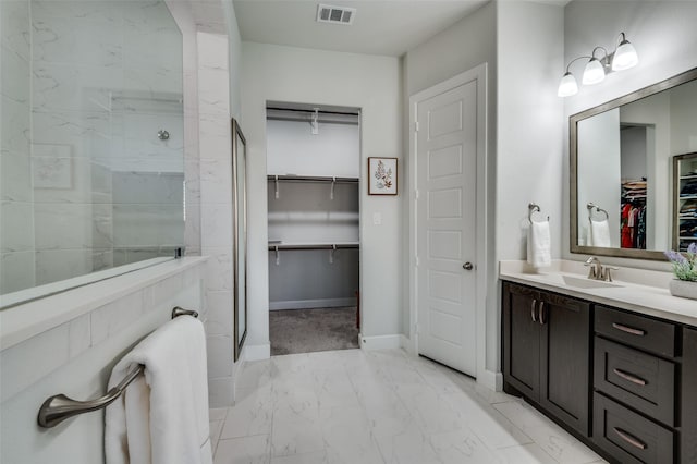 3128 Lexington Dr, Celina, TX 75009 - full bath featuring marble look tiles, a spacious closet, vanity, and a tile shower