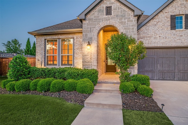 3128 Lexington Dr, Celina, TX 75009 - view of front of house featuring an attached garage, brick siding, concrete driveway, and a shingled roof