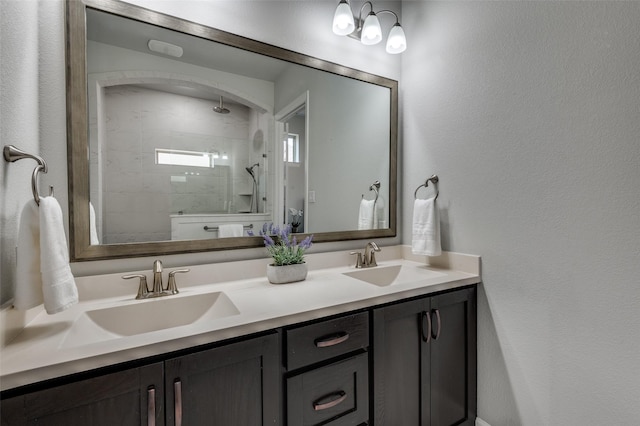 3128 Lexington Dr, Celina, TX 75009 - bathroom with double vanity, a tile shower, and a textured wall