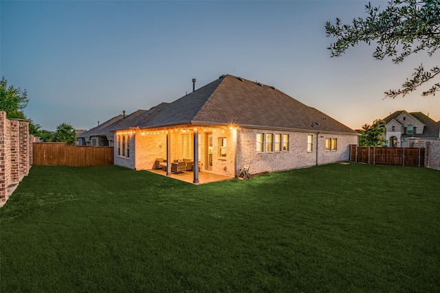 3128 Lexington Dr, Celina, TX 75009 - back of property at dusk featuring a fenced backyard, a patio area, brick siding, and a shingled roof