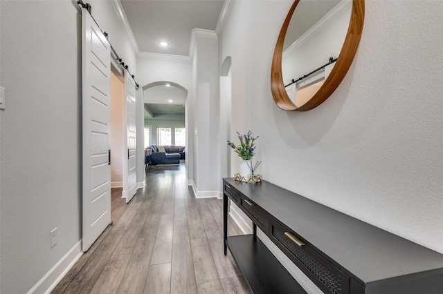 3128 Lexington Dr, Celina, TX 75009 - corridor with crown molding, a barn door, wood finished floors, arched walkways, and recessed lighting