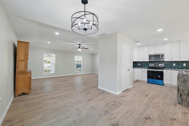 3638 Parkmont St, Mesquite, TX 75150 - kitchen featuring light wood-style floors, recessed lighting, white cabinetry, tasteful backsplash, and appliances with stainless steel finishes