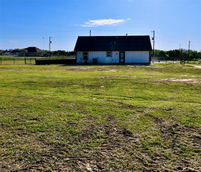 exterior space featuring fence and a lawn