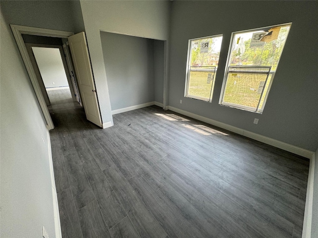 409 S Main St, Bonham, TX 75418 - unfurnished bedroom with baseboards, dark wood-style floors, and a closet