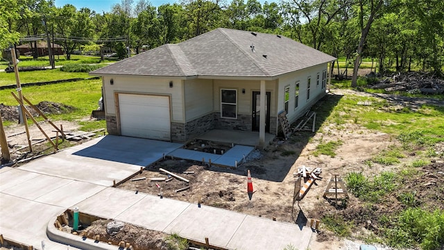 409 S Main St, Bonham, TX 75418 - ranch-style home featuring a garage, a shingled roof, stone siding, and driveway