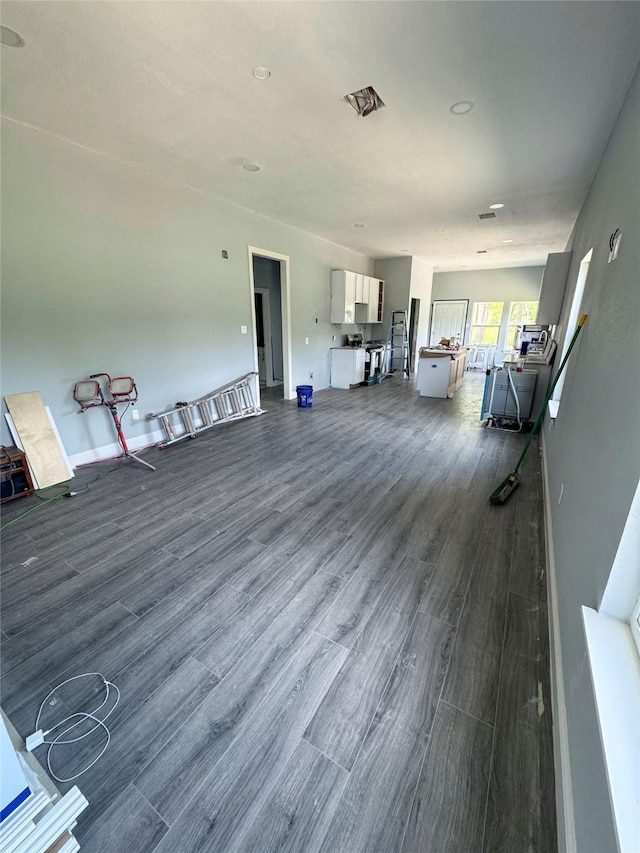 409 S Main St, Bonham, TX 75418 - living area featuring dark wood-type flooring and baseboards