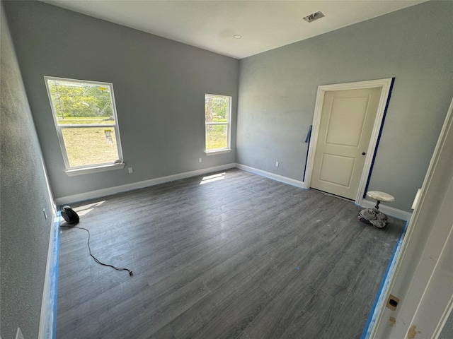 409 S Main St, Bonham, TX 75418 - spare room with plenty of natural light, dark wood finished floors, and baseboards