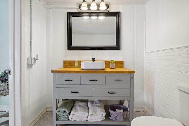 bathroom featuring vanity, marble finish floor, and toilet