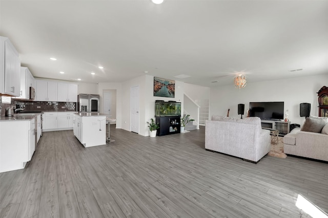 1335 Panorama Dr, Forney, TX 75126 - living area with light wood-style flooring, baseboards, visible vents, and recessed lighting
