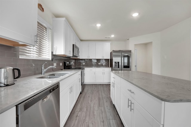 1335 Panorama Dr, Forney, TX 75126 - kitchen with light stone counters, backsplash, a sink, a kitchen island, and appliances with stainless steel finishes