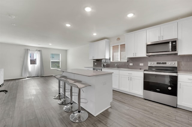 1335 Panorama Dr, Forney, TX 75126 - kitchen featuring a sink, a wealth of natural light, appliances with stainless steel finishes, and a breakfast bar