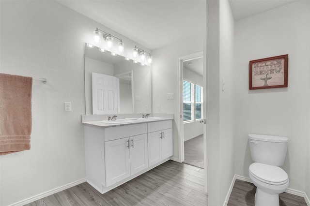 1335 Panorama Dr, Forney, TX 75126 - bathroom featuring baseboards, toilet, wood finished floors, and a sink