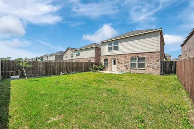 1335 Panorama Dr, Forney, TX 75126 - back of property featuring a yard, brick siding, a fenced backyard, and a patio