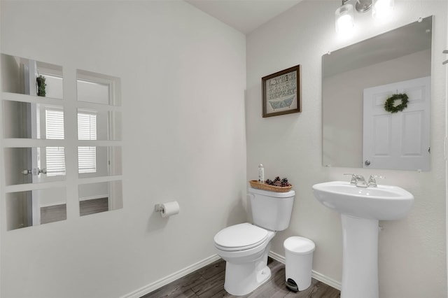 1335 Panorama Dr, Forney, TX 75126 - half bath featuring a sink, toilet, wood finished floors, and baseboards